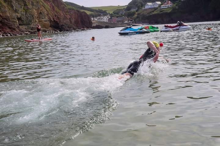 Participant swimming along the South Devon coastline.