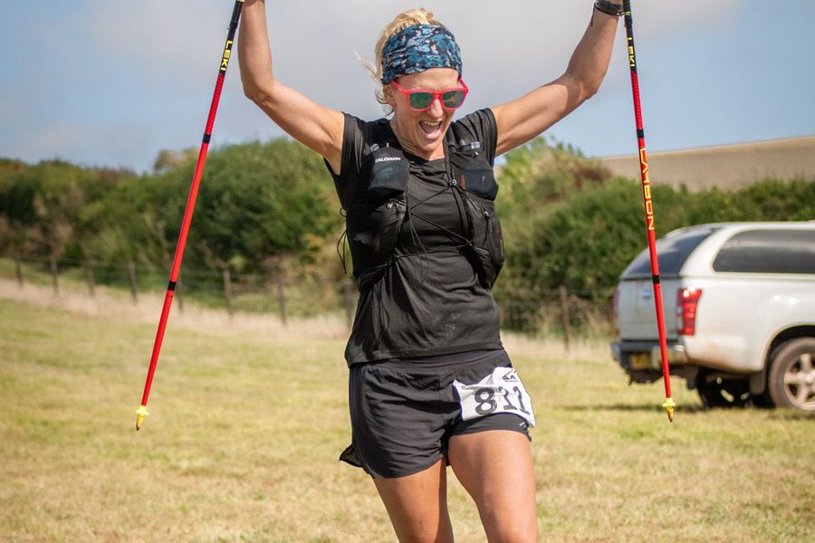 Ultra runner crossing rugged coastal trails at Something Wild Festival.